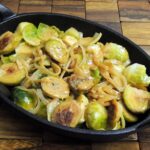 White Wine Braised Brussels Sprouts in a cast iron pan.