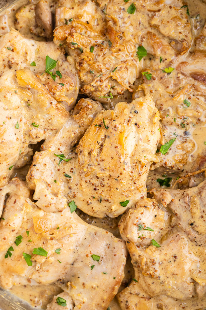 Extreme closeup photo of Creamy Mustard Chicken in a skillet.