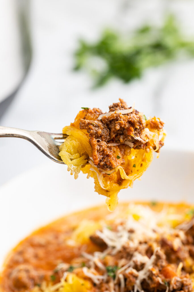 Closeup of a bite of Instant Pot Bolognese Sauce (Low Carb) on a fork.