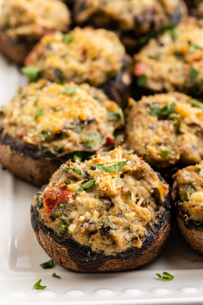 Close up of Keto Crab Stuffed Mushrooms on a white serving tray.