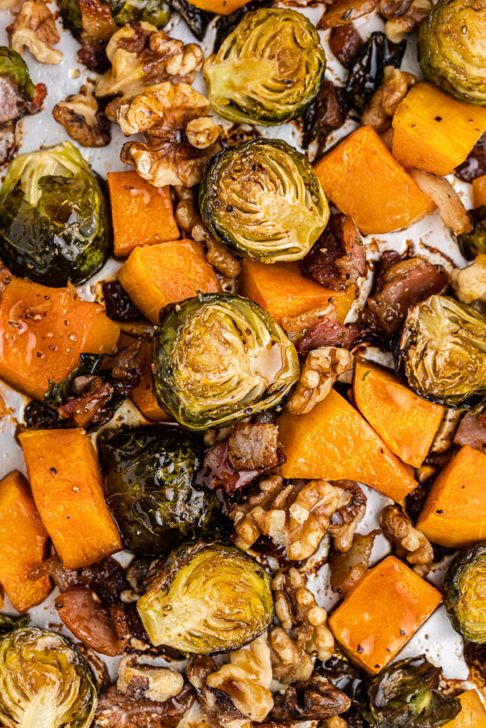 Overhead view of Maple Roasted Brussels Sprouts and Butternut Squash on a baking sheet.