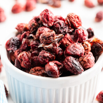 Sugar-free dried cranberries in a white ramekin.