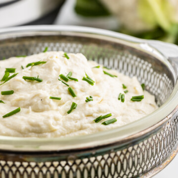 Instant Pot Mashed Cauliflower in a glass serving dish.