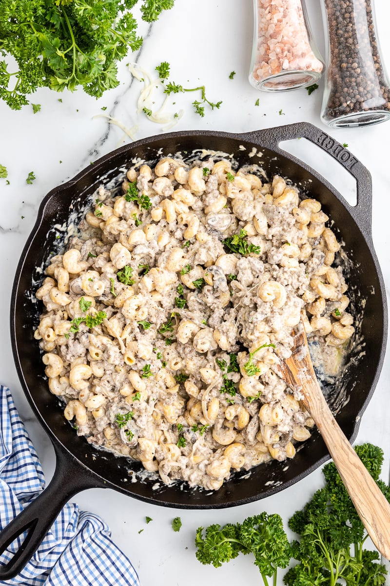 Low Carb Mushroom Swiss Cheeseburger Pasta in a cast iron skillet with a wooden spoon.