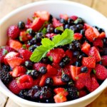 Keto mixed berry salad in a white bowl.