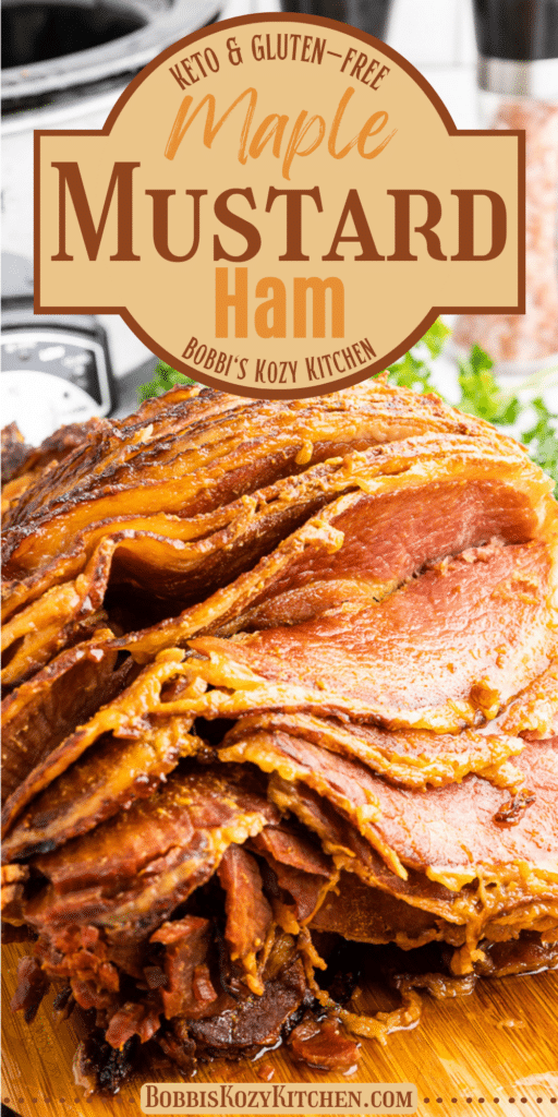 Close up of Keto Slow Cooker Maple Mustard Ham on a cutting board with several slices cut and the pieces folded down so you can see the juicy interior.