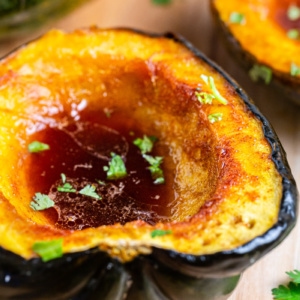 Low Carb Brown Sugar Chile Roasted Acorn Squash on a wooden cutting board.