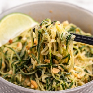 Spicy Peanut Cucumber Noodle Salad in a gray bowl with chopsticks.