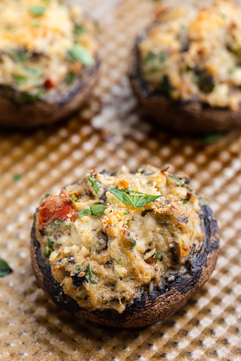 Cooked stuffed mushrooms on a baking sheet.