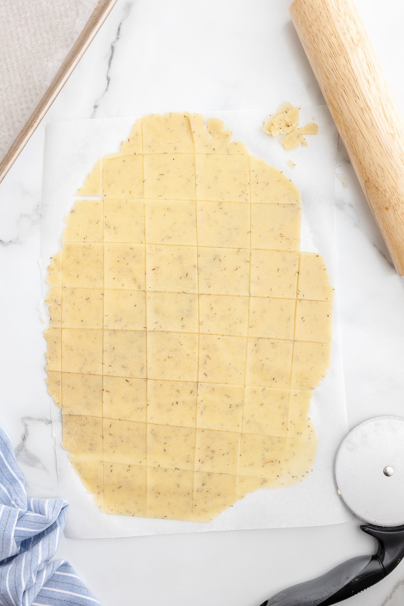Using a pizza cutter, cut the dough into squares to form crackers.