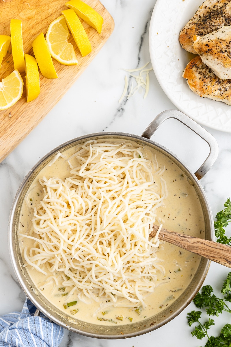 Hearts of palm linguini noodles being tossed in the lemon asparagus cream sauce.