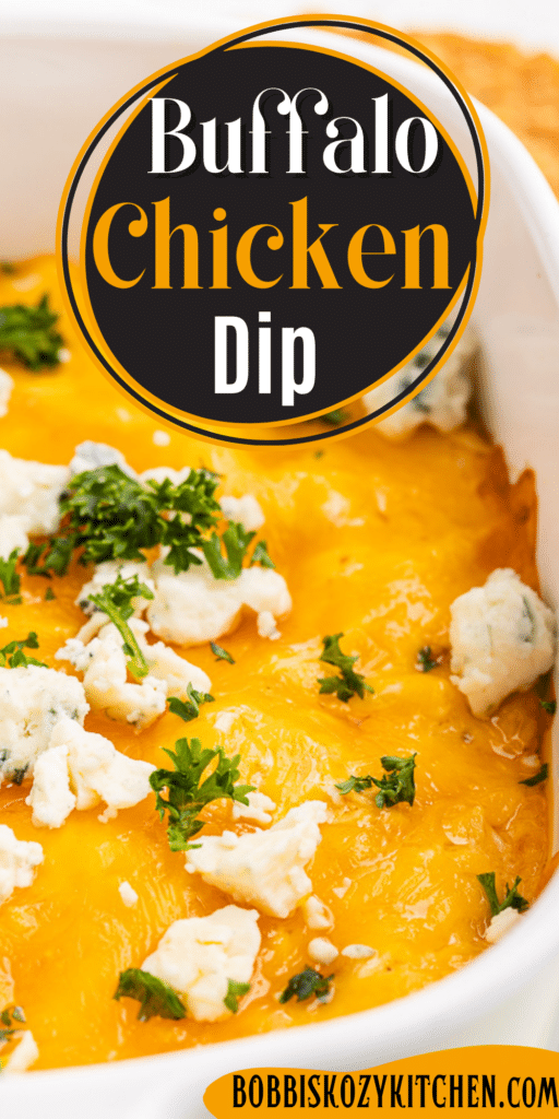 Pinterest pin with the closeup of Buffalo Chicken Dip aka Chicken Crack in a white casserole dish topped with blue cheese crumbles.