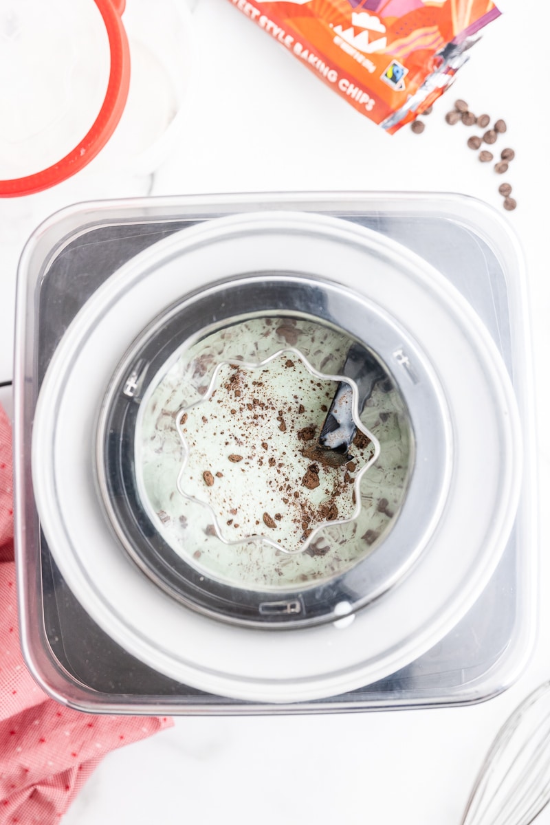 Overhead view of an ice cream maker after chocolate chips have been added to the ice cream.