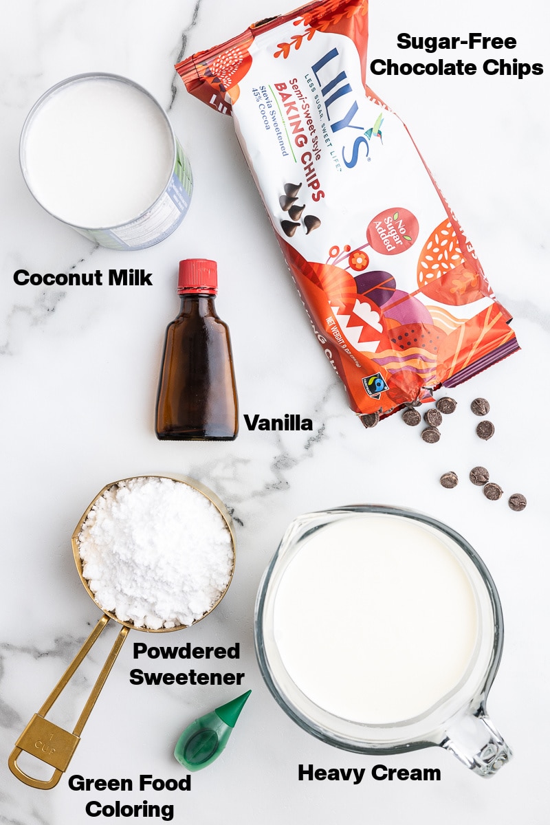 All of the ingredients needed to make Keto Mint Chocolate Chip Ice Cream on a white counter.