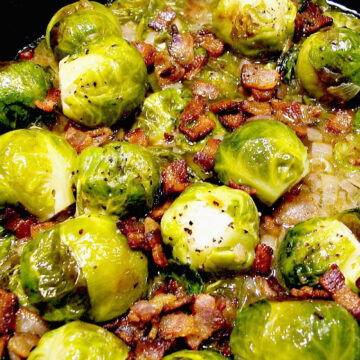 Overhead view of brussels sprouts in a Dutch oven sauteed with bacon and shallots.