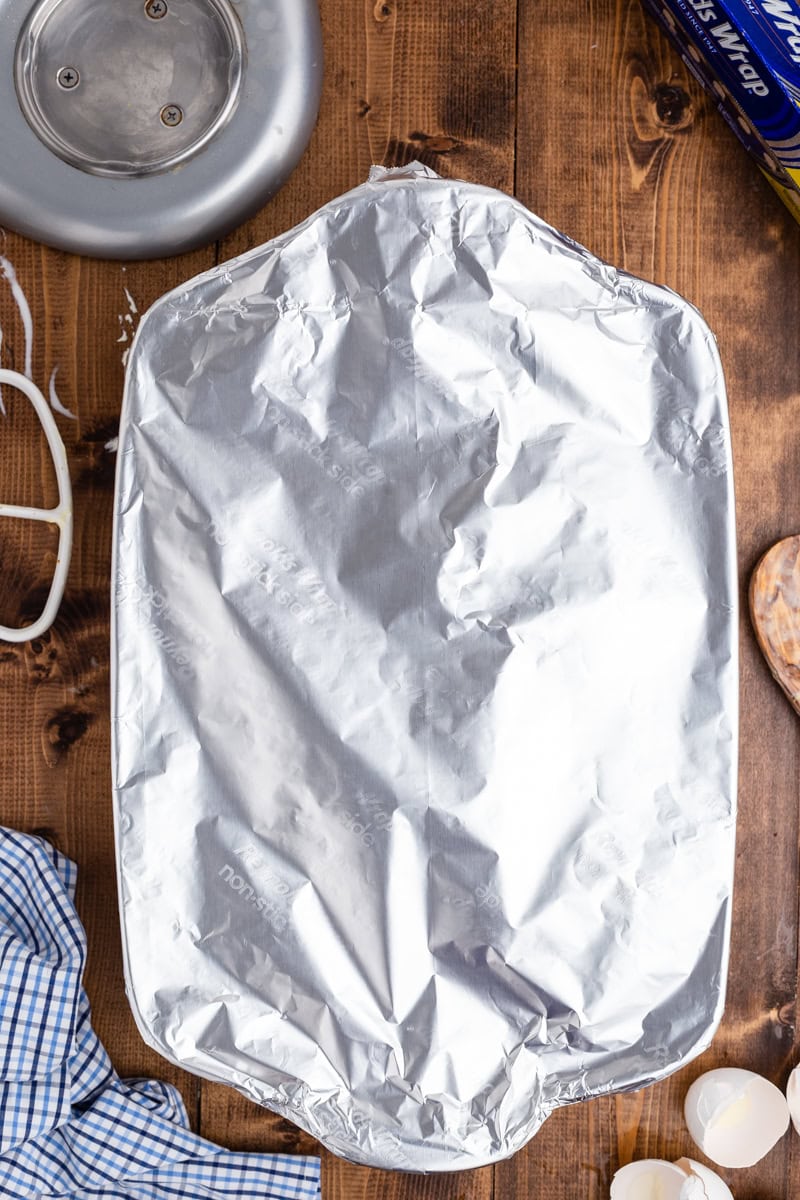 A 9 x 13 baking dish filled with Keto Blueberry French Toast Bake and covered with foil.