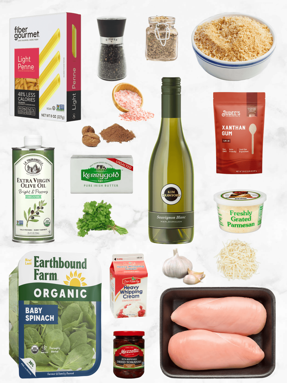 All of the ingredients needed to make a Chicken Florentine Casserole on a white marble background.